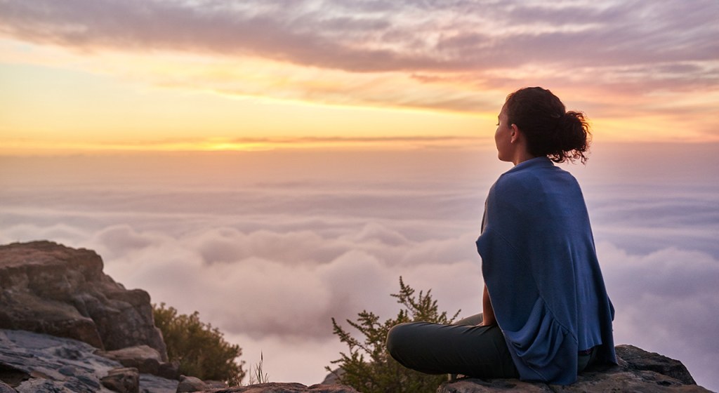 A person practicing how to meditate in a serene environment